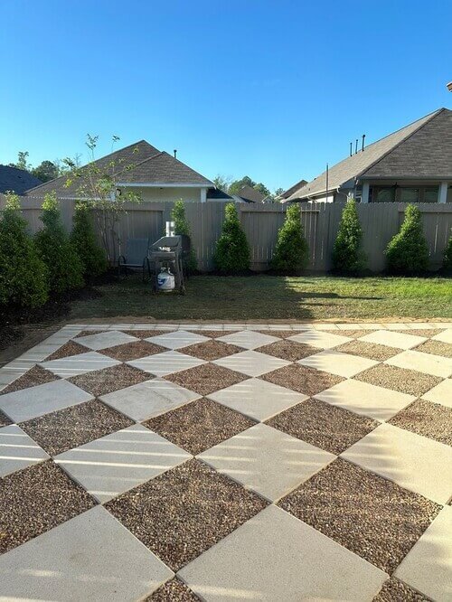 Achieve a timeless patio look with a checkered pattern of pavers and gravel