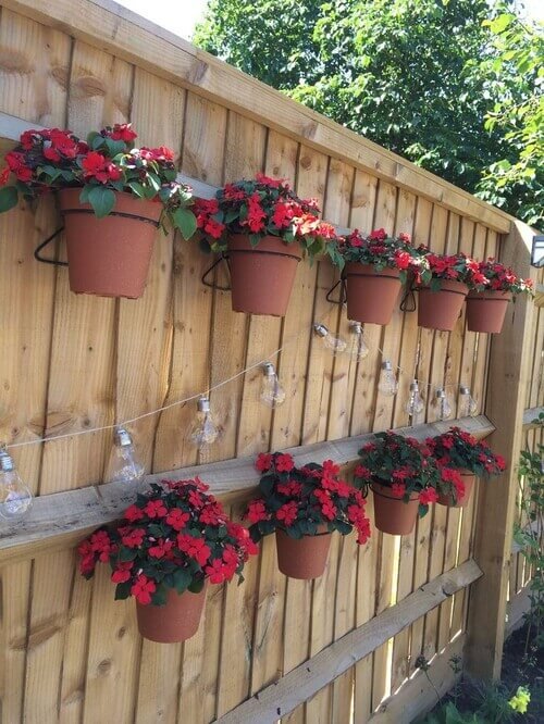 Create a warm, rustic focal point by mounting terracotta pots on your wall
