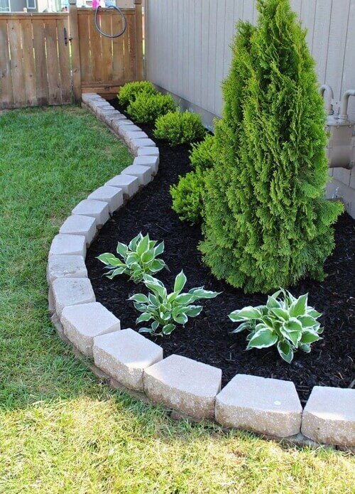 Add elegant definition to your garden beds with a curved stone border