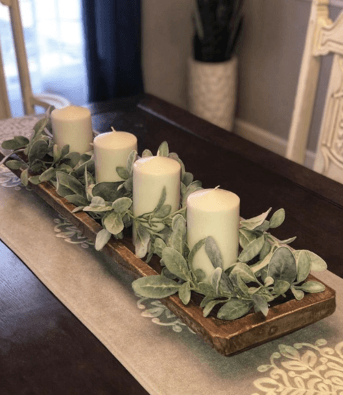 Rustic centerpiece: branches, candles & grains in a wooden dough bowl