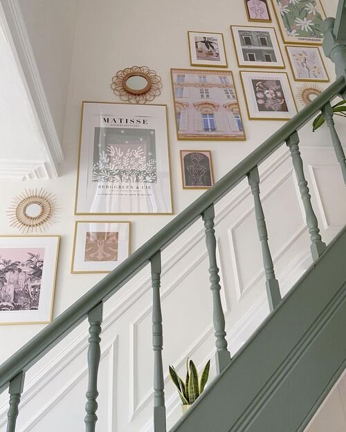 Modern art prints paired with sunburst mirrors