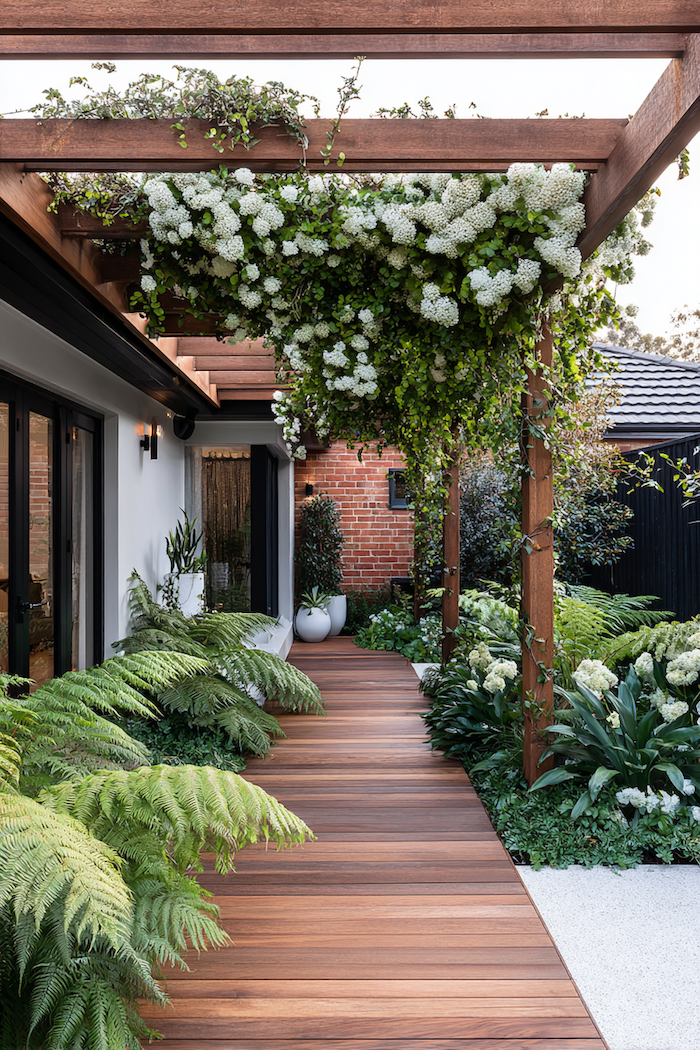 Create a natural woodland walk with a timber garden path embraced by lush foliage