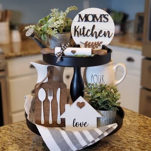 A tiered tray adorned with lush greenery