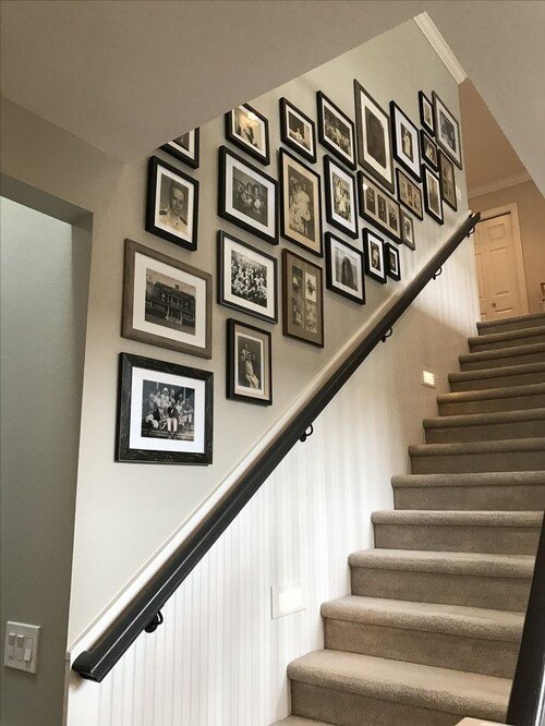 A blend of old family photos in black and wood frames