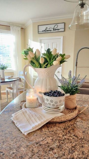 A fresh spring arrangement of tulips, blueberries, and candles