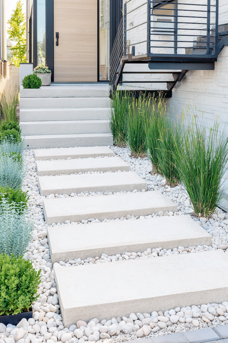 Achieve sleek contemporary style with a modern concrete pathway accented by gravel