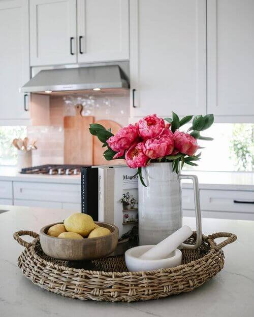A striking blend of bold florals, rustic dough bowls, and stacked cookbooks