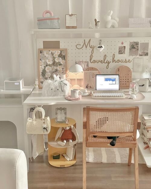 Create a bright and cheerful workspace with white and playful desk decor