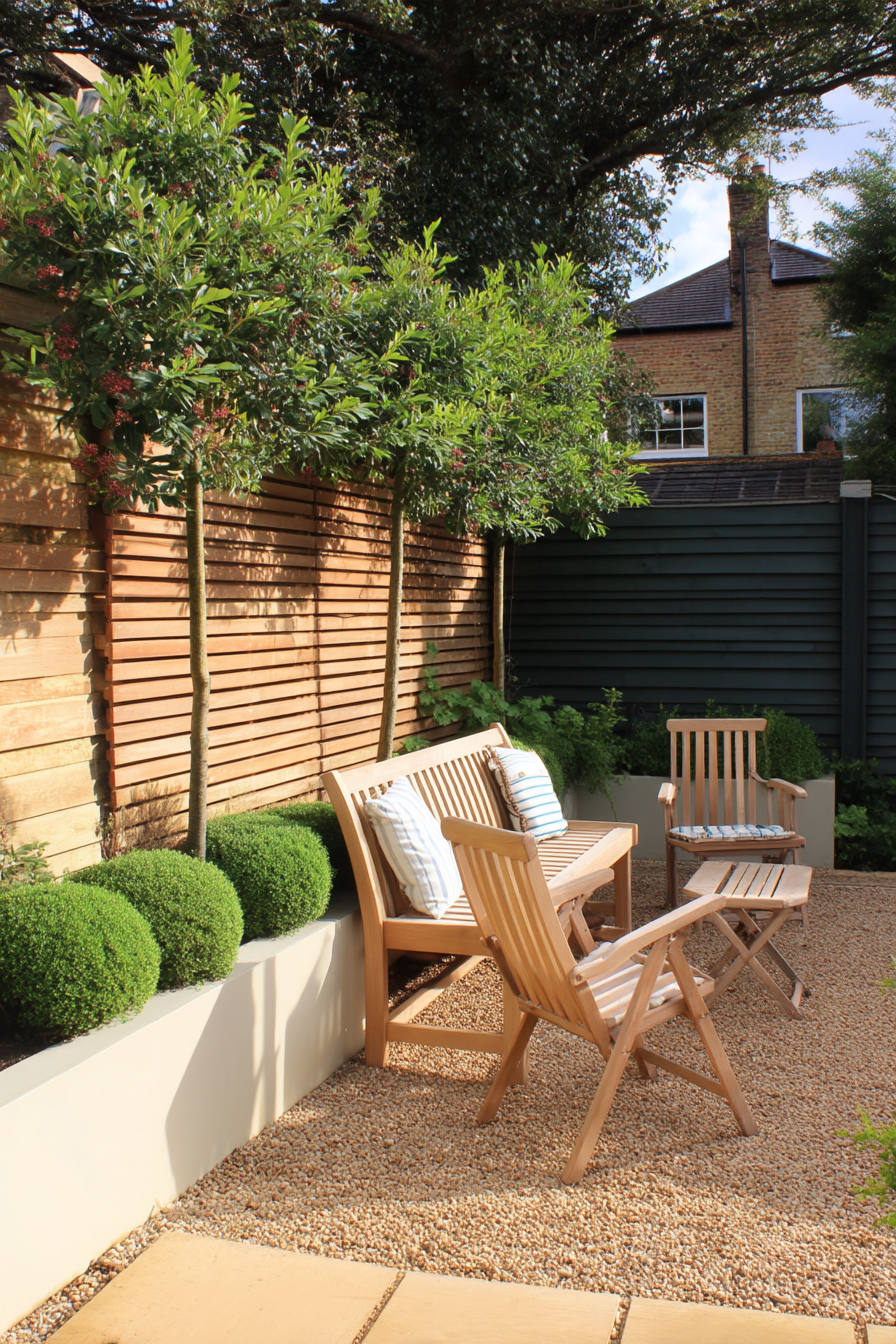 Define a sleek outdoor lounge with a modern minimalist gravel seating area